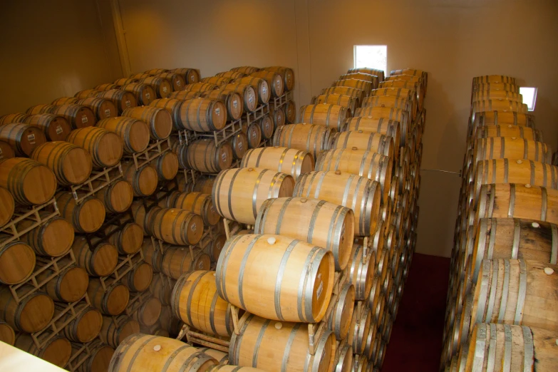 several stacks of wooden casks in a cellar