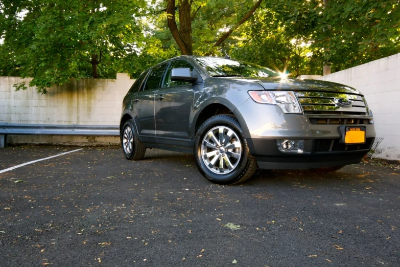 the front end of a grey ford edge parked in a lot