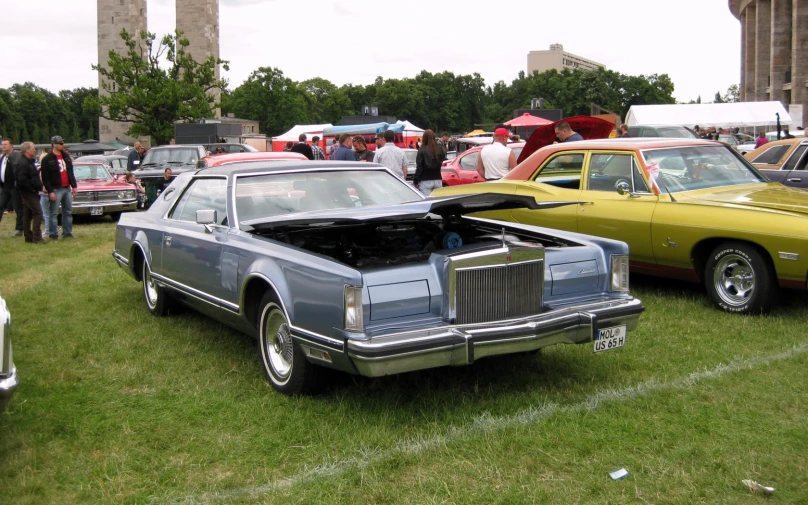 vintage cars are parked at a car show