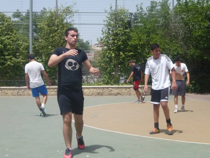 several people are playing on an outdoor court