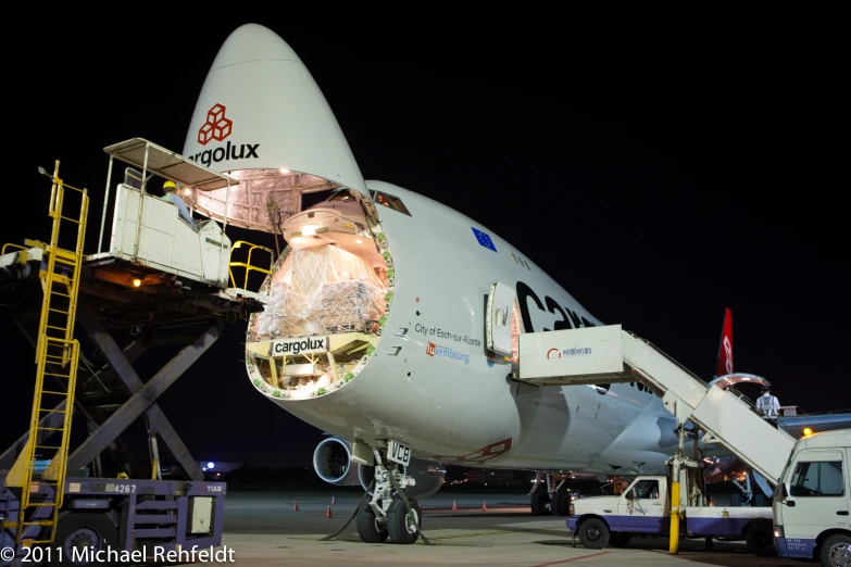 the front of an airplane with its doors open at night