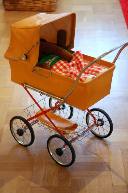a toy wagon with a blanket wrapped inside of it