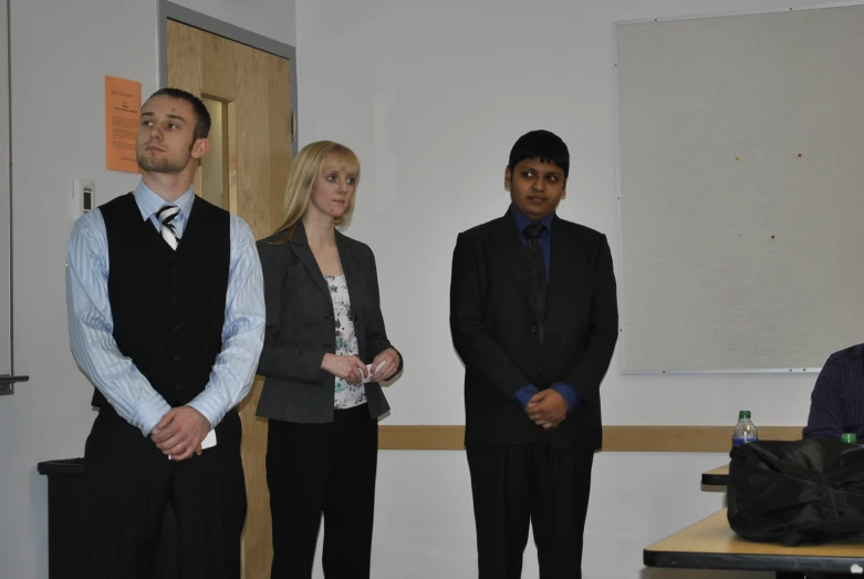 there are people standing in front of a class room