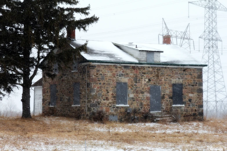 a lonely old building surrounded by bare trees