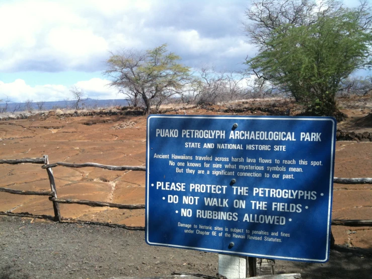 a sign posted on the side of a road telling people to stop