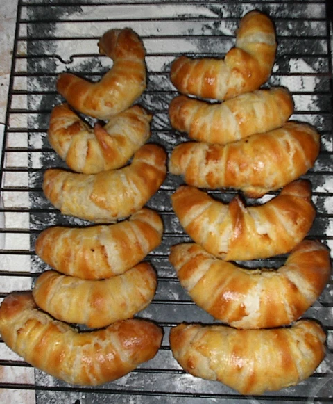 eight pastries on a silver rack, ready to be baked