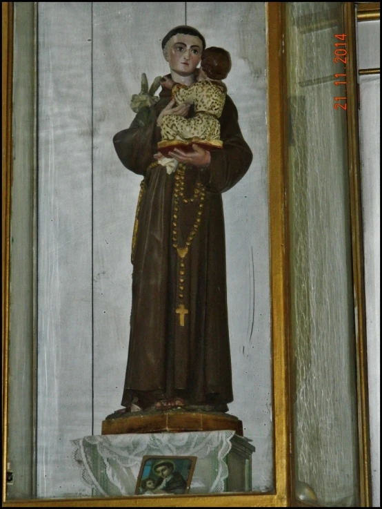 a painted statue holding the head of a child