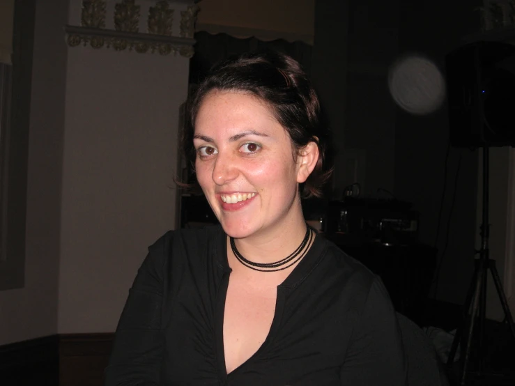 a woman wearing a black top is smiling