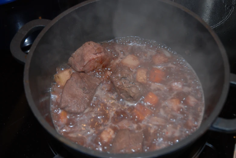 a large pot filled with stew on a stove