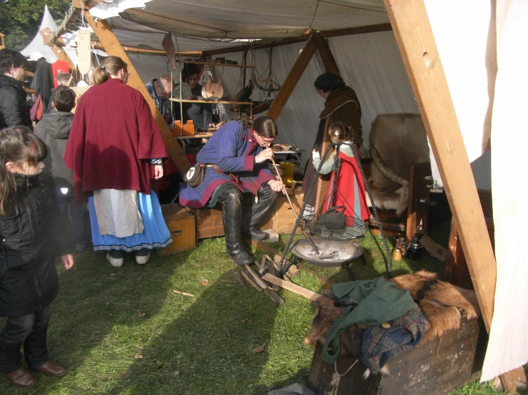 some people are gathered at an outdoor fair