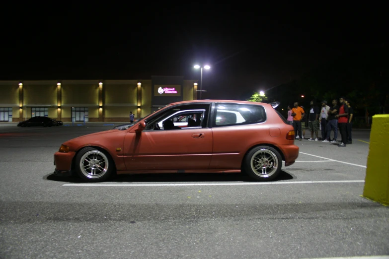 a red car parked in a parking lot