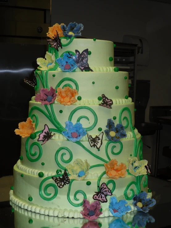 a multi layer cake with white frosting and erflies on top