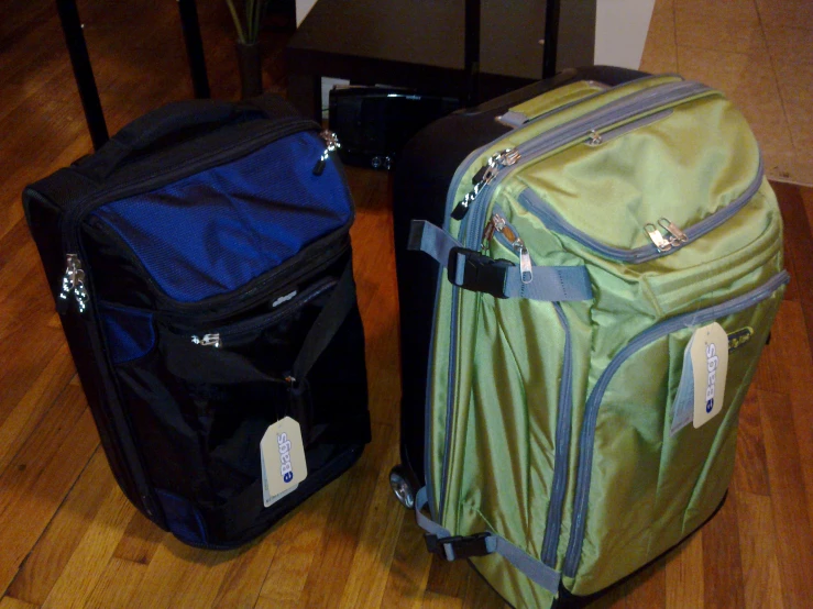 two suitcases sitting next to each other on the floor