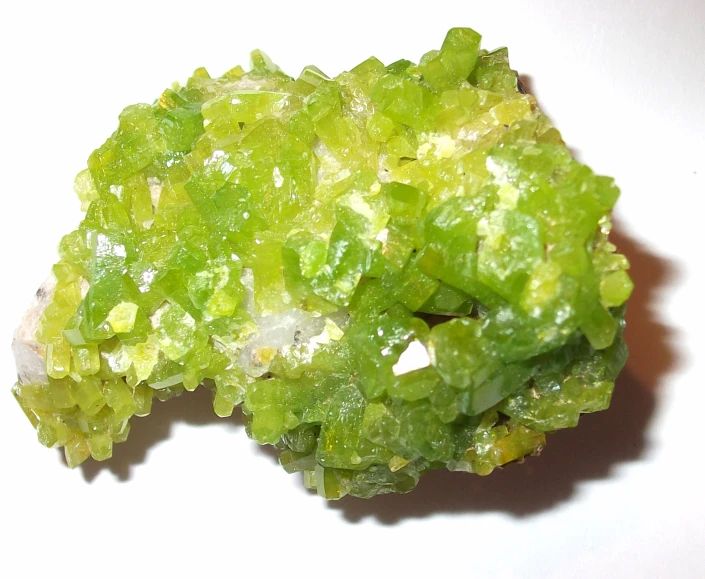 some very pretty green crystals on a white table