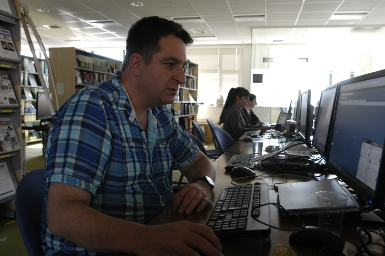 a man sitting in front of a computer keyboard