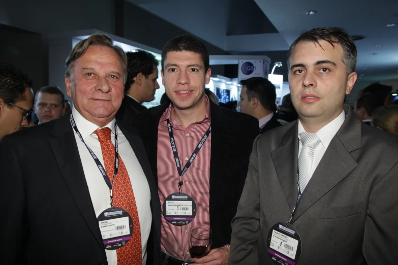 three people wearing business attire are standing together