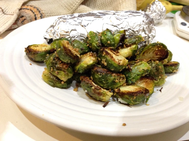 there is a plate of brussels sprouts wrapped in foil