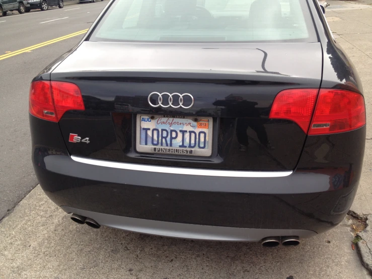 a car parked on a side walk with the license plate of an accord