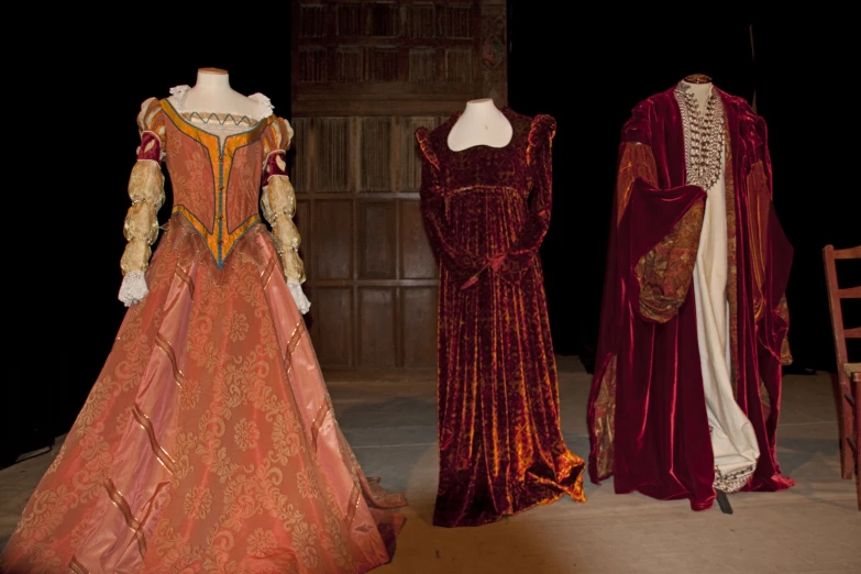 several vintage costumes displayed with each other on display