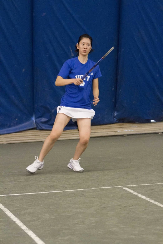 a young woman hitting a tennis ball with a racquet