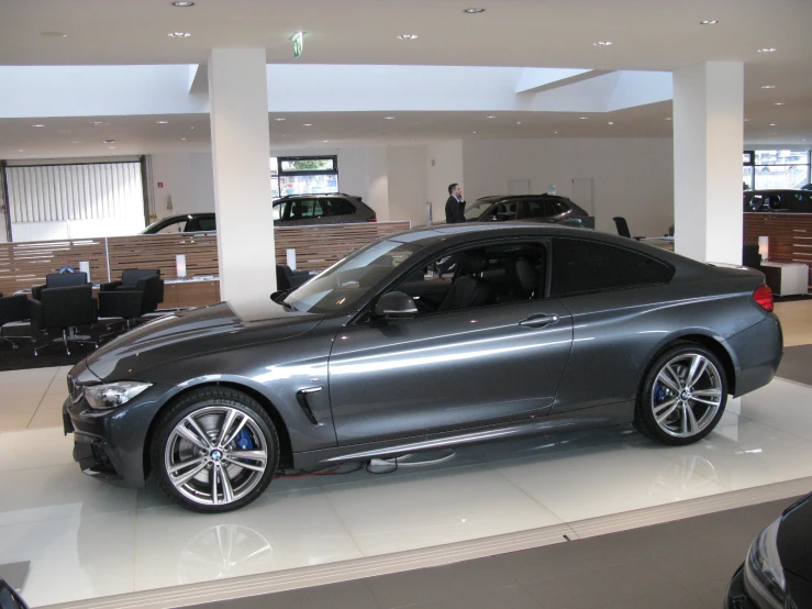 a bmw dealership with two luxury cars parked in the background