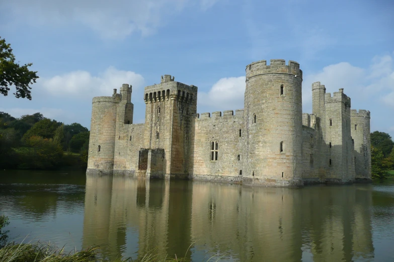 an ancient castle sitting on the side of a lake