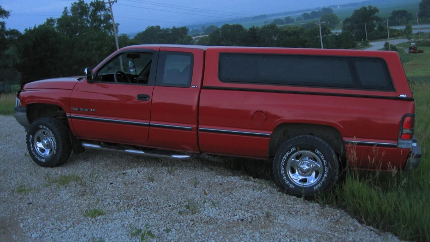 a red pick up truck parked on the side of the road