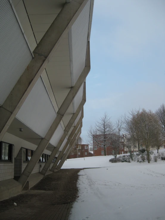 a view of a building next to snow covered ground