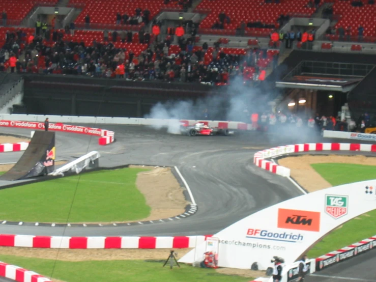 a car on a race track in front of an audience
