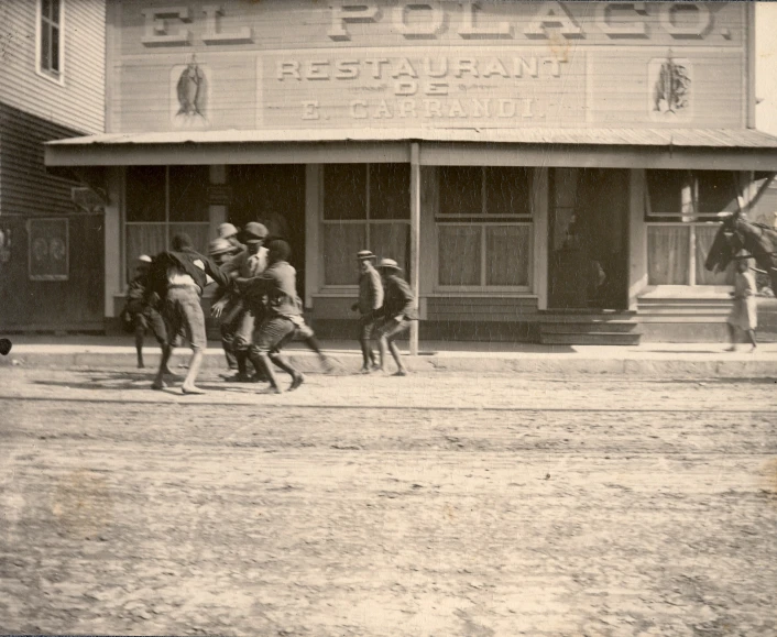 several people standing outside a restaurant on horses