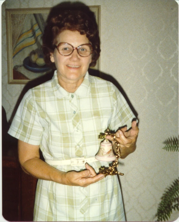 a woman in a plaid shirt holding soing in her hands