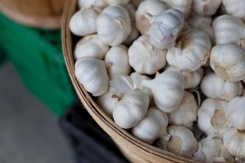 many garlic cloves in baskets are shown