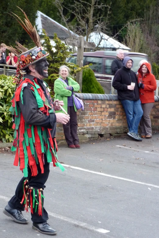 a man dressed in a costume walking down the road