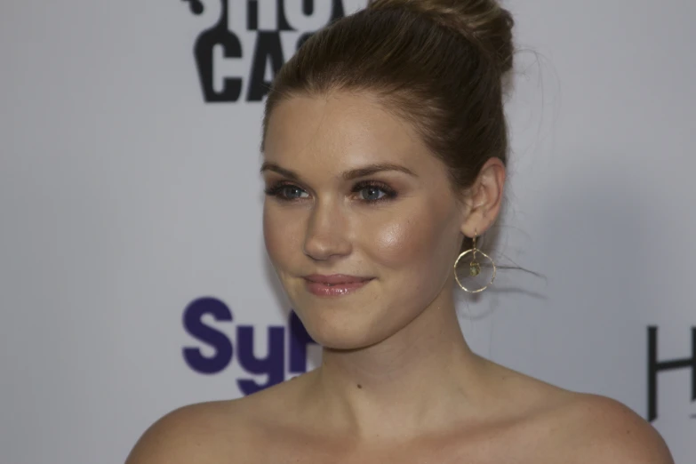 a beautiful woman with large earrings and a black top