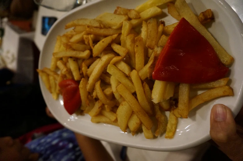 a plate with a pizza on it with french fries