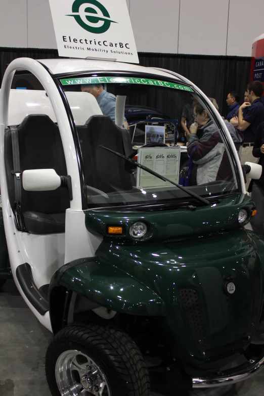 a green and white vehicle at an expo