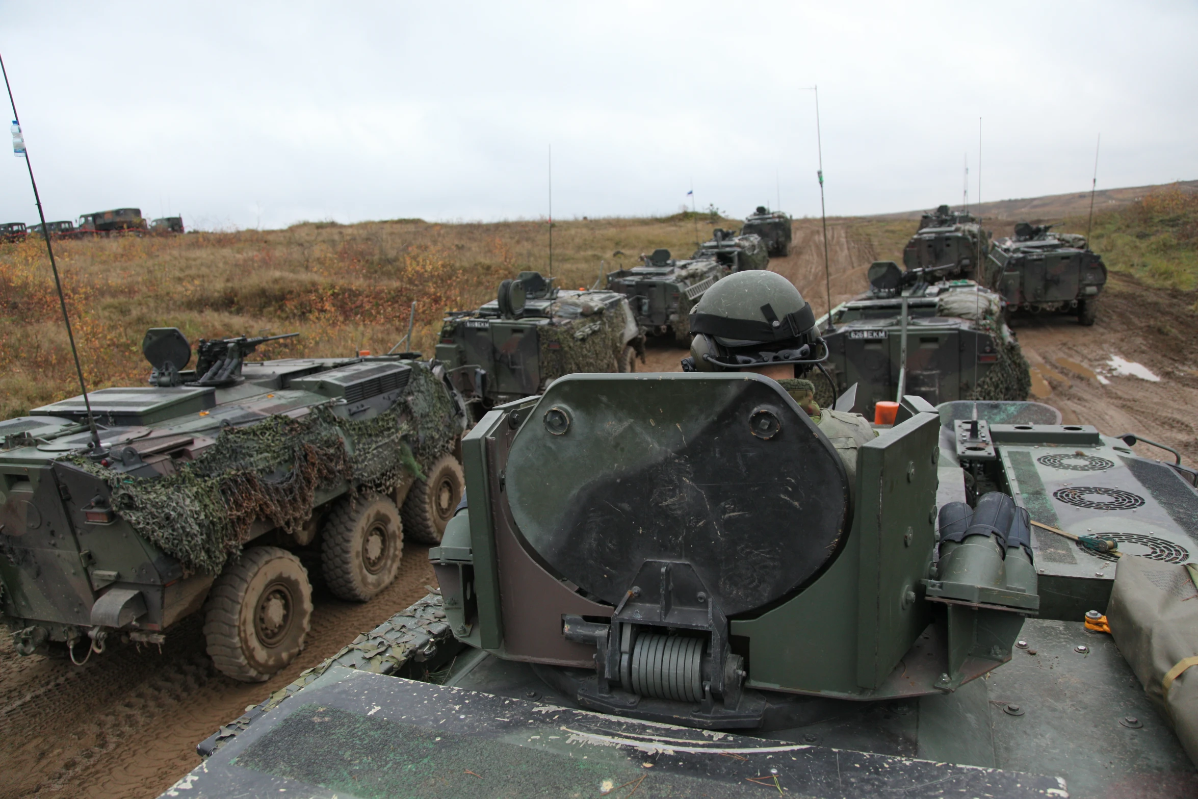 a military field with tanks and guns in it