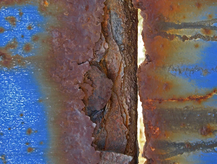 rusty metal panel with rust spots on the top