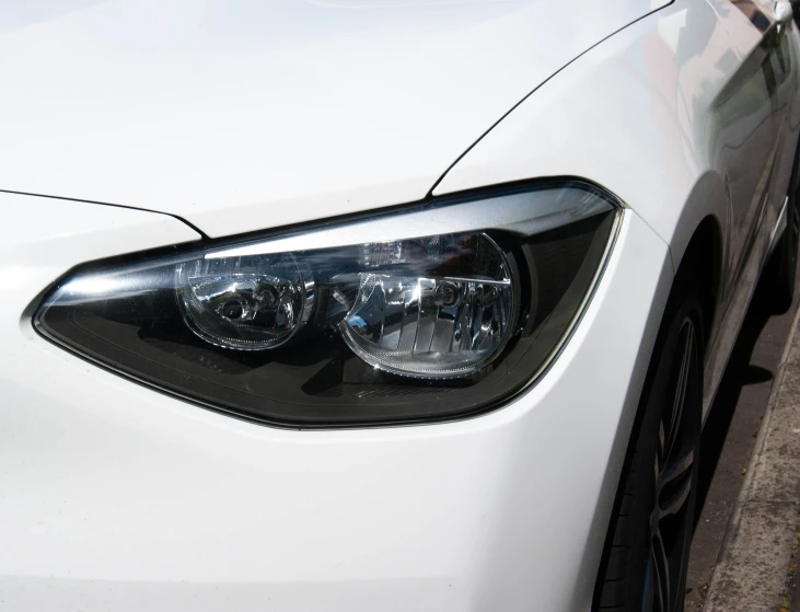 headlight on a car in front of a city street