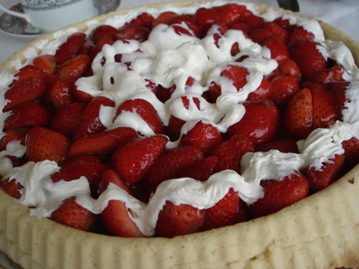 a dessert with some whipped cream and strawberries in the middle