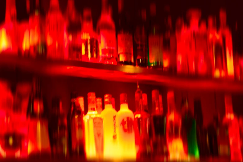 blurred image of liquor bottles and candles in a bar