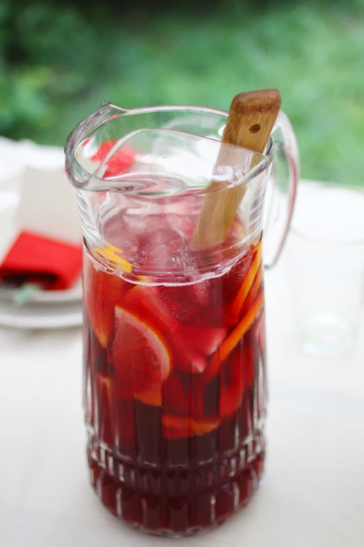 a pitcher filled with liquid and a wooden stick