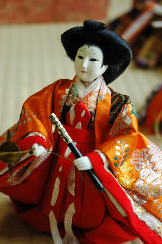 doll posed with fan, standing on hard wood floor