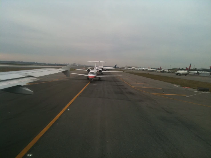 the small engine airplane is parked on the runway