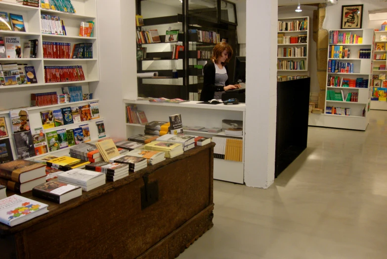 a woman looking at books at a book store