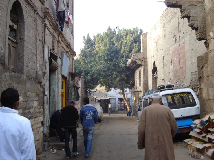 some people are standing in the narrow city street