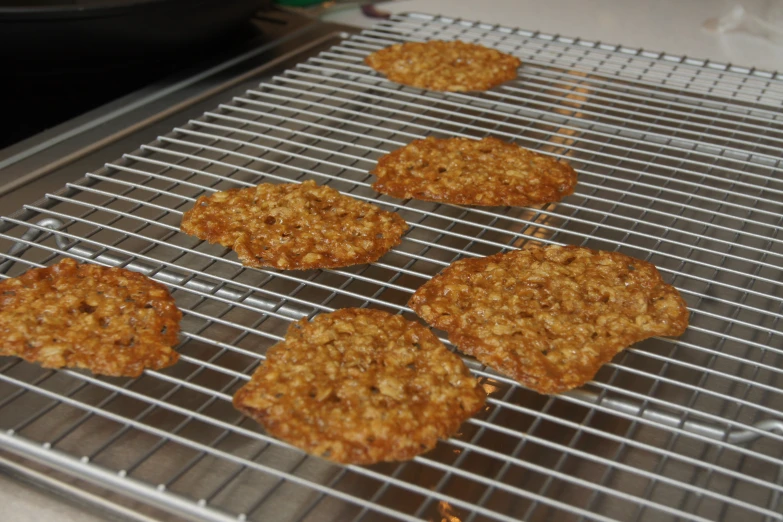 an assortment of cookies are cooling on a wire rack