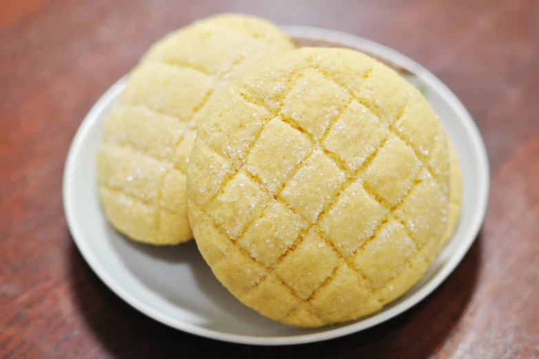 two pieces of yellow cake on a white plate