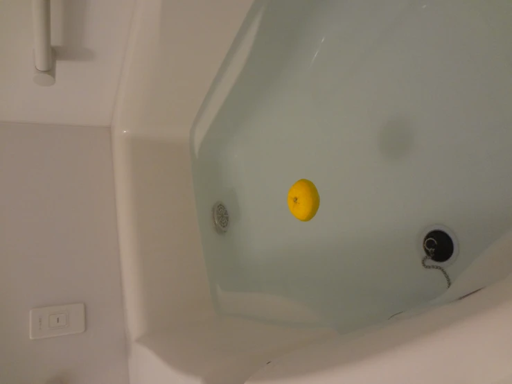 the bubble bath has a yellow object in it