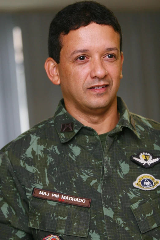 a male in army uniform posing for a po